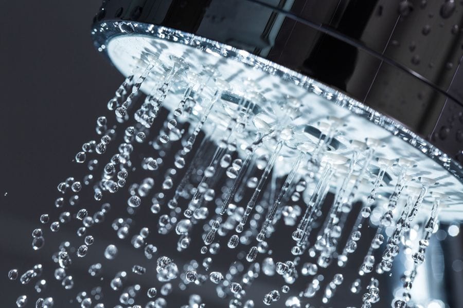 Image of water pouring out of shower head. Should I Buy a Tankless Water Heater Instead?