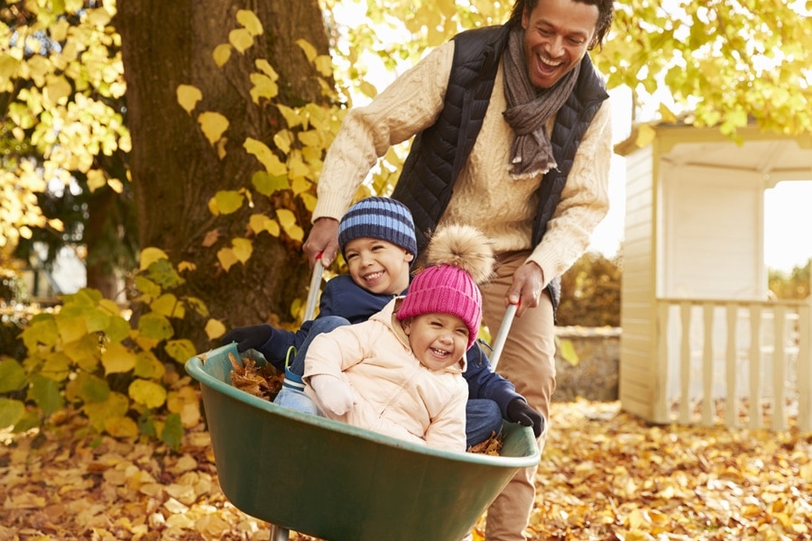 family outdoors in fall weather showing why it's important to schedule a fall furnace clean and check