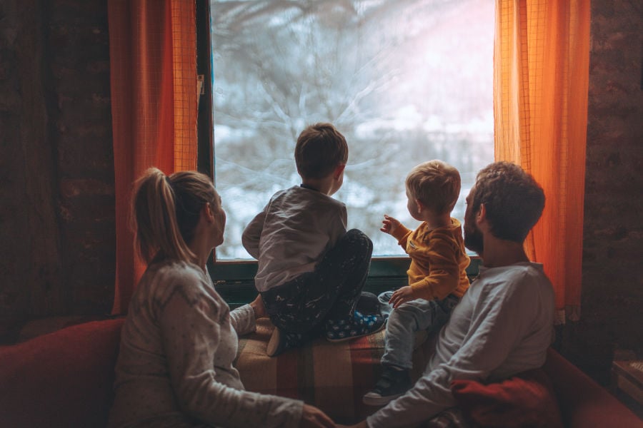 Family staying warm inside their home during extreme cold weather after learning how to keep the heat indoors.