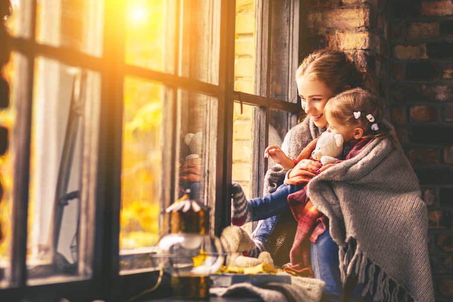 Blog Title: Three Reasons to Consider a Geothermal Heat Pump Photo: mother and baby son in autumn window